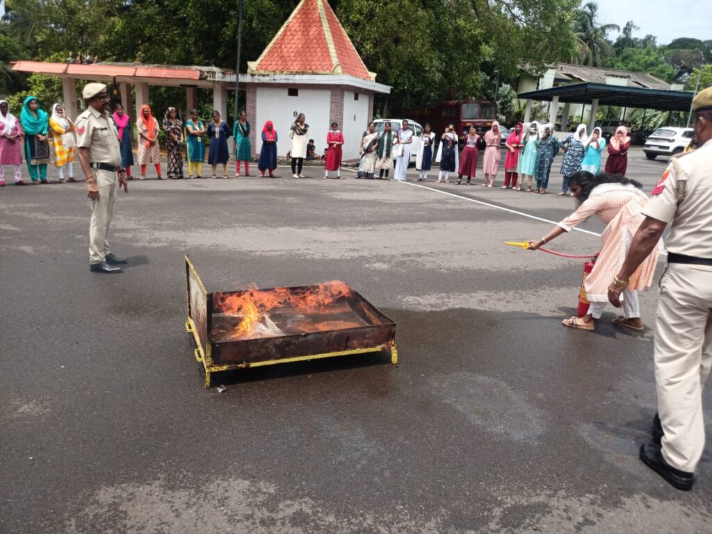 Female participant practicing how to use Fire extinguisher